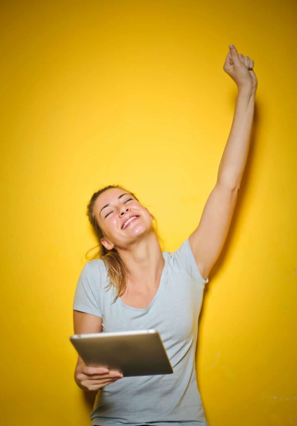 Women with iPad celebrating