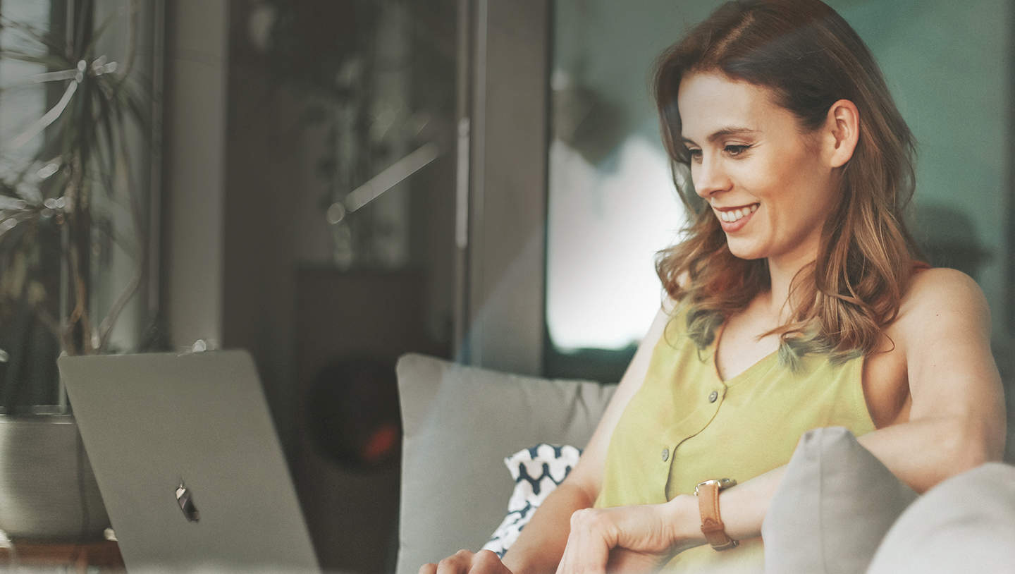 Woman with laptop smiling