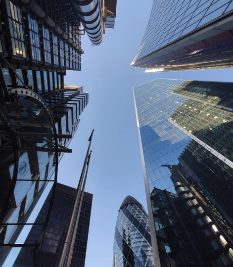 Deliver local at scale image of looking up from the ground at shinny skyscrapers