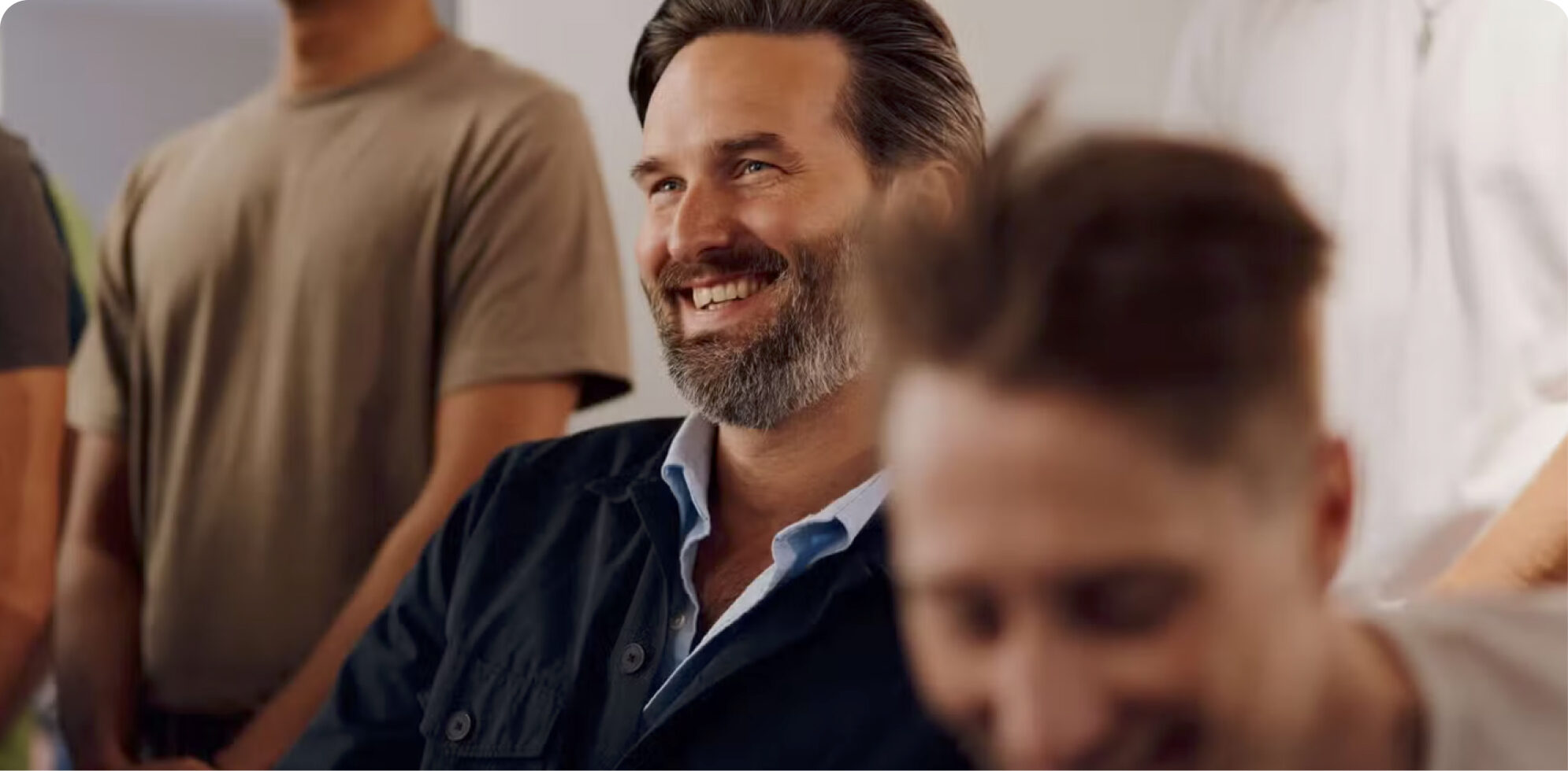 Large hero image for Brite Payments Abouts us page showcasing members of staff smiling.