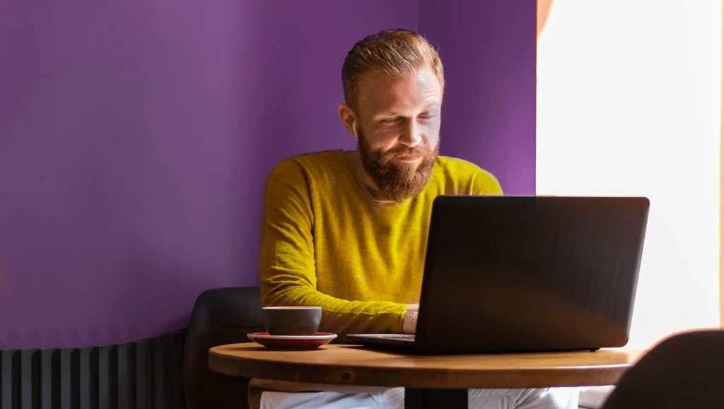 Man with laptop making an Account to Account payment