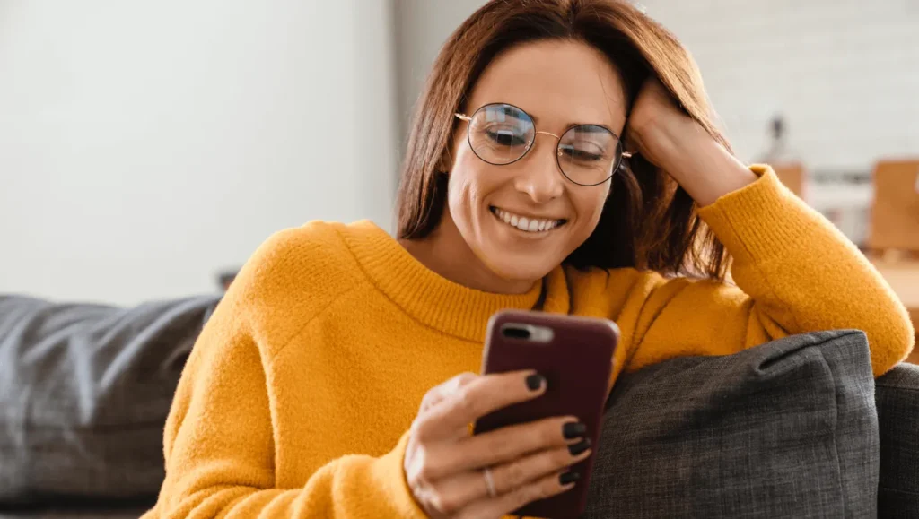 Woman with smartphone smiling