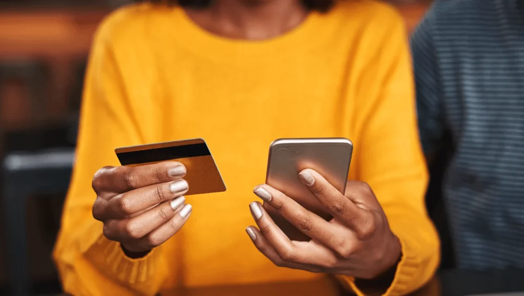 Woman paying with card through her smartphone
