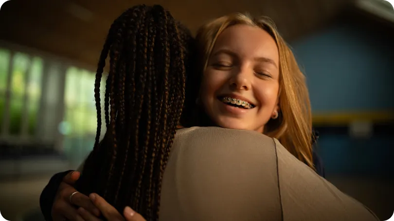 Girl hugging and smiling